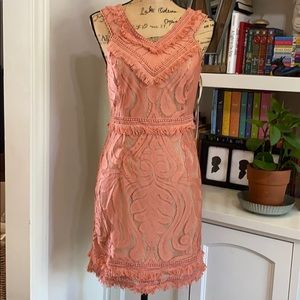 Fitted peach dress with fringe and lace